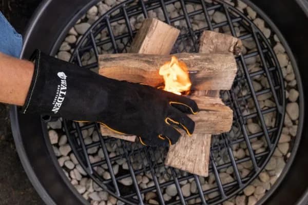 Work gloves on a stack of split firewood