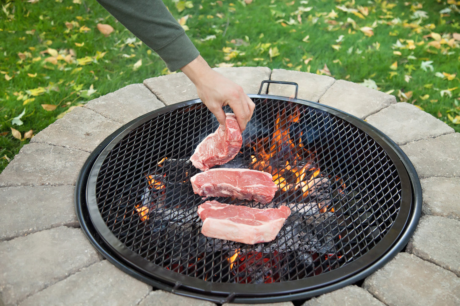 Cooking meat on a BBQ grill grate