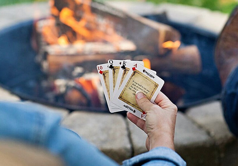 Playing fire-side chats card game around fire pit