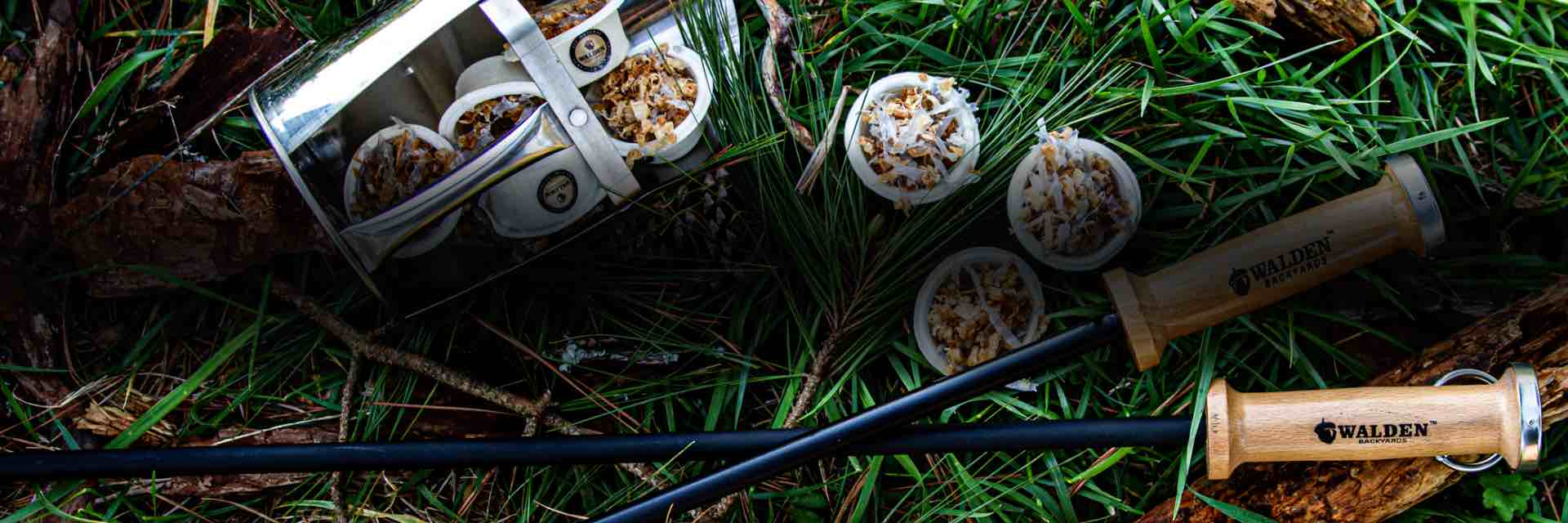 Fireside accessories, including fire stoker and fire starters, on grass